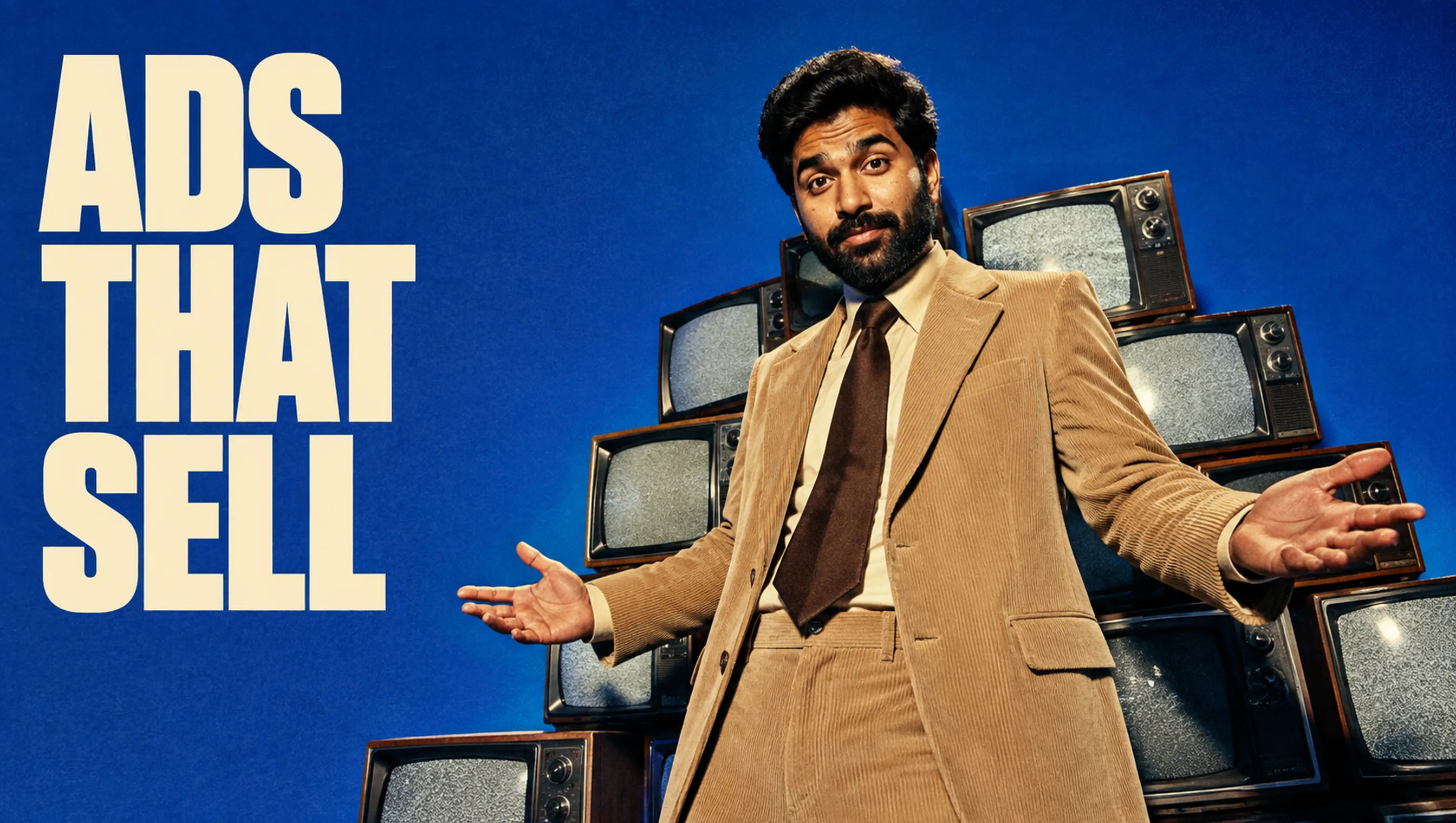 Deenu Khan in front of a wall of vintage televisions beside the words Ads That Sell